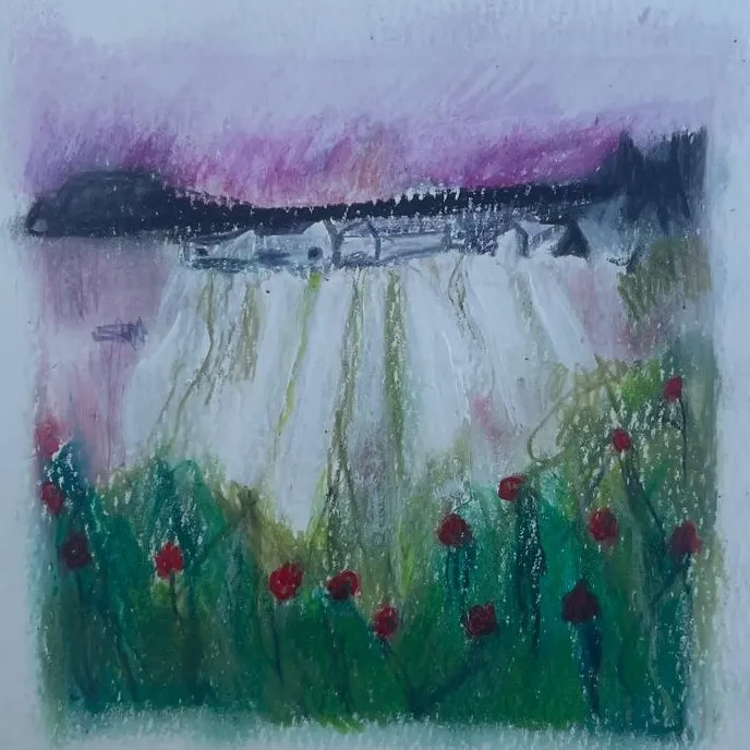 Soft pastel of a lakeside village behind a field of red flowers